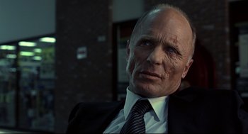 Movie still from “A History of Violence” (2005), directed by David Cronenberg – An older man in a suit and tie looking into the distance; Close Up shot, Low angle