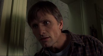 Movie still from “A History of Violence” (2005), directed by David Cronenberg – A person wearing a plaid shirt; Close Up shot, Low angle