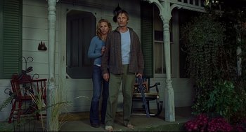 Movie still from “A History of Violence” (2005), directed by David Cronenberg – A man and a woman standing in front of a house; Medium shot, Low angle
