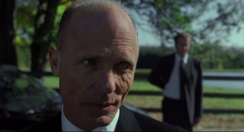 Movie still from “A History of Violence” (2005), directed by David Cronenberg – An older man in a suit and tie; Close Up shot, Low angle