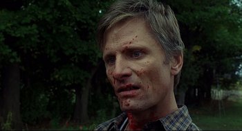 Movie still from “A History of Violence” (2005), directed by David Cronenberg – A person with blood all over his face; Close Up shot, Low angle