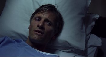 Movie still from “A History of Violence” (2005), directed by David Cronenberg – A person laying in a hospital bed; Close Up shot, High angle