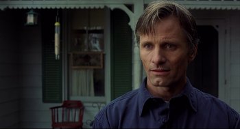 Movie still from “A History of Violence” (2005), directed by David Cronenberg – A person wearing a blue shirt; Close Up shot, Low angle