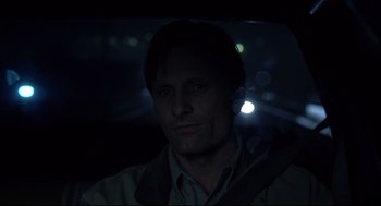 Movie still from “A History of Violence” (2005), directed by David Cronenberg – A man sitting in a car in the dark; Close Up shot, Over the shoulder angle