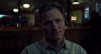 Movie still from “A History of Violence” (2005), directed by David Cronenberg – A person wearing a green shirt; Close Up shot, Over the shoulder angle