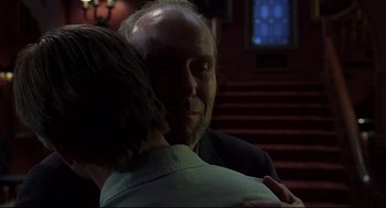 Movie still from “A History of Violence” (2005), directed by David Cronenberg – A man and a woman hugging in a dark room; Close Up shot, Over the shoulder angle
