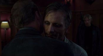 Movie still from “A History of Violence” (2005), directed by David Cronenberg – Two men are hugging each other in a dark room; Close Up shot, Over the shoulder angle