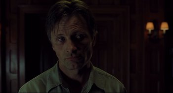 Movie still from “A History of Violence” (2005), directed by David Cronenberg – A person wearing a green shirt; Close Up shot, Low angle
