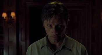 Movie still from “A History of Violence” (2005), directed by David Cronenberg – A person wearing a green shirt; Close Up shot, Low angle