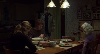 Movie still from “A History of Violence” (2005), directed by David Cronenberg – A group of people sitting around a table eating food; Wide shot, Over the shoulder angle