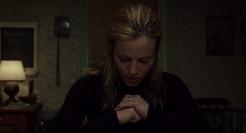Movie still from “A History of Violence” (2005), directed by David Cronenberg – A woman with her hands clasped together in prayer; Close Up shot, High angle