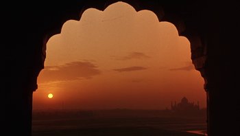 Movie still from “A Little Princess” (1995), directed by Alfonso Cuarón – The sun is setting over a large body of water; Extreme Wide shot, Low angle
