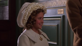 Movie still from “A Little Princess” (1995), directed by Alfonso Cuarón – A little girl wearing a white dress and a white hat; Close Up shot, High angle