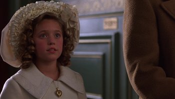 Movie still from “A Little Princess” (1995), directed by Alfonso Cuarón – A young girl wearing a white dress and a white hat; Close Up shot, Over the shoulder angle