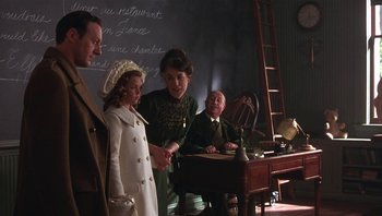 Movie still from “A Little Princess” (1995), directed by Alfonso Cuarón – A group of people standing in a room; Medium shot, Over the shoulder angle