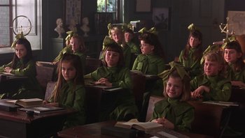 Movie still from “A Little Princess” (1995), directed by Alfonso Cuarón – A group of children sitting at desks in a classroom; Medium shot, High angle