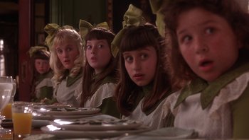 Movie still from “A Little Princess” (1995), directed by Alfonso Cuarón – A group of young girls sitting at a dinner table; Close Up shot, Over the shoulder angle