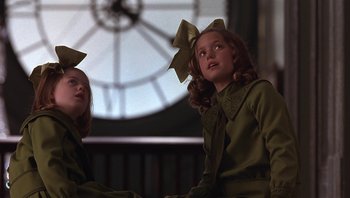 Movie still from “A Little Princess” (1995), directed by Alfonso Cuarón – Two young girls in green dresses with bows on their heads; Medium shot, Low angle