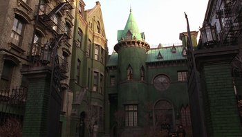 Movie still from “A Little Princess” (1995), directed by Alfonso Cuarón – A large green building with a green roof; Extreme Wide shot, High angle