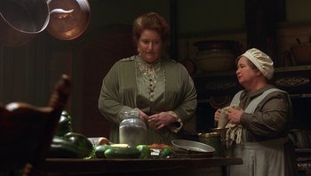 Movie still from “A Little Princess” (1995), directed by Alfonso Cuarón – Two women standing at a table in a kitchen; Medium shot, Low angle