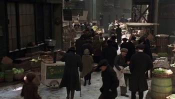 Movie still from “A Little Princess” (1995), directed by Alfonso Cuarón – A group of people standing around a market; Wide shot, High angle