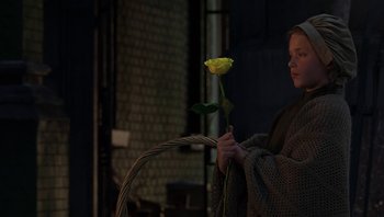 Movie still from “A Little Princess” (1995), directed by Alfonso Cuarón – A woman holding a yellow rose in her hand; Medium shot, Over the shoulder angle