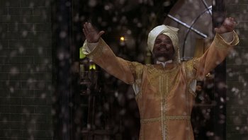 Movie still from “A Little Princess” (1995), directed by Alfonso Cuarón – A man wearing a turban waves to the crowd; Medium shot, Low angle