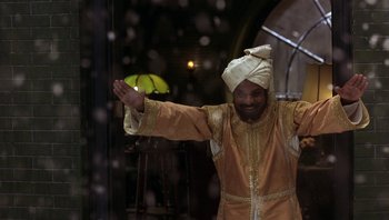 Movie still from “A Little Princess” (1995), directed by Alfonso Cuarón – A man wearing a turban is waving his hands; Medium shot, Low angle