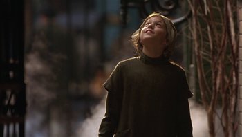 Movie still from “A Little Princess” (1995), directed by Alfonso Cuarón – A young boy standing in the street looking up at the sky; Medium shot, Low angle