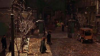 Movie still from “A Little Princess” (1995), directed by Alfonso Cuarón – Two people walking down the street in the dark; Extreme Wide shot, High angle
