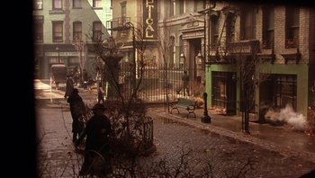 Movie still from “A Little Princess” (1995), directed by Alfonso Cuarón – People are walking down the street in a city; Wide shot, High angle
