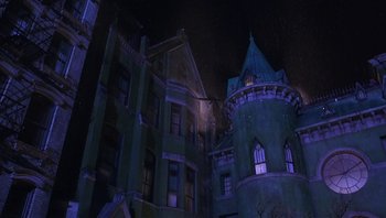 Movie still from “A Little Princess” (1995), directed by Alfonso Cuarón – A building that is lit up at night time; Extreme Wide shot, Low angle