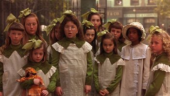 Movie still from “A Little Princess” (1995), directed by Alfonso Cuarón – A group of young girls wearing green and white dresses; Medium shot, High angle
