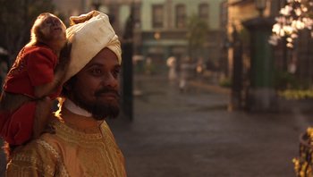 Movie still from “A Little Princess” (1995), directed by Alfonso Cuarón – A man with a beard wearing a turban; Close Up shot, Over the shoulder angle