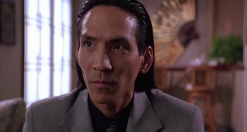 Movie still from “A Low Down Dirty Shame” (1994), directed by Keenen Ivory Wayans – A person wearing a suit and tie; Close Up shot, Low angle