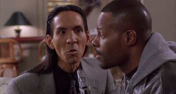 Movie still from “A Low Down Dirty Shame” (1994), directed by Keenen Ivory Wayans – Two men are talking to each other in a room; Close Up shot, Low angle