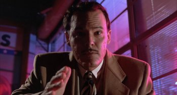 Movie still from “A Low Down Dirty Shame” (1994), directed by Keenen Ivory Wayans – A person wearing a suit and tie; Close Up shot, Low angle