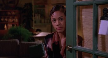 Movie still from “A Low Down Dirty Shame” (1994), directed by Keenen Ivory Wayans – A woman standing at the door of a room; Medium shot, Over the shoulder angle