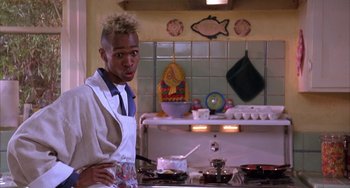 Movie still from “A Low Down Dirty Shame” (1994), directed by Keenen Ivory Wayans – A man standing in a kitchen preparing a meal; Close Up shot, Low angle