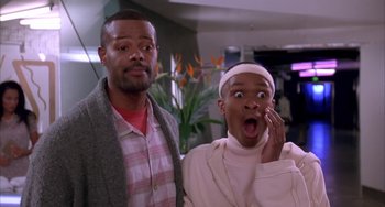 Movie still from “A Low Down Dirty Shame” (1994), directed by Keenen Ivory Wayans – A man standing next to a woman in front of a plant; Close Up shot, Low angle