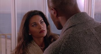 Movie still from “A Low Down Dirty Shame” (1994), directed by Keenen Ivory Wayans – A man and a woman looking at one another in a mirror; Close Up shot, Over the shoulder angle