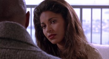 Movie still from “A Low Down Dirty Shame” (1994), directed by Keenen Ivory Wayans – A person with long brown hair; Close Up shot, Over the shoulder angle