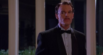 Movie still from “A Low Down Dirty Shame” (1994), directed by Keenen Ivory Wayans – A man in a tuxedo standing in front of a window; Close Up shot, Low angle