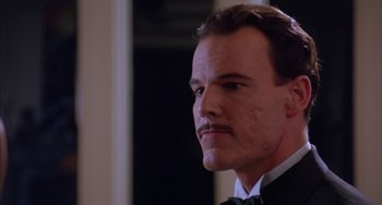 Movie still from “A Low Down Dirty Shame” (1994), directed by Keenen Ivory Wayans – A person wearing a suit and a bow tie; Close Up shot, Low angle