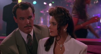 Movie still from “A Low Down Dirty Shame” (1994), directed by Keenen Ivory Wayans – A man standing next to a woman in a room; Close Up shot, Over the shoulder angle