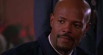 Movie still from “A Low Down Dirty Shame” (1994), directed by Keenen Ivory Wayans – A man with a bald head is looking at the camera; Close Up shot, Over the shoulder angle