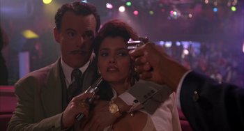 Movie still from “A Low Down Dirty Shame” (1994), directed by Keenen Ivory Wayans – A man and a woman posing for a picture in a nightclub; Close Up shot, Low angle
