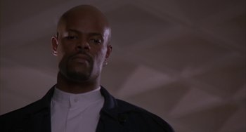Movie still from “A Low Down Dirty Shame” (1994), directed by Keenen Ivory Wayans – A man with a beard is looking at the camera; Close Up shot, Low angle