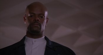 Movie still from “A Low Down Dirty Shame” (1994), directed by Keenen Ivory Wayans – A man with a beard is looking at the camera; Close Up shot, Low angle