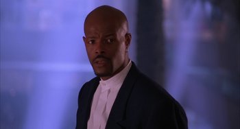 Movie still from “A Low Down Dirty Shame” (1994), directed by Keenen Ivory Wayans – A man in a white shirt and a black jacket; Close Up shot, Low angle